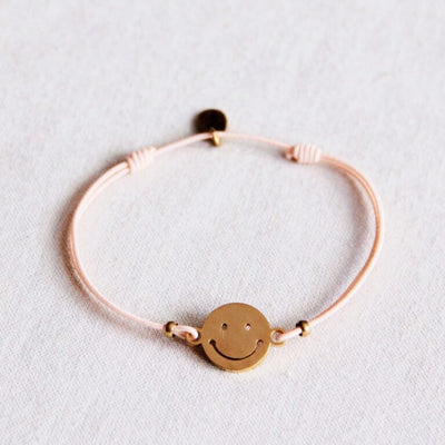 Elastisches Armband mit Smiley - pfirsich/gold